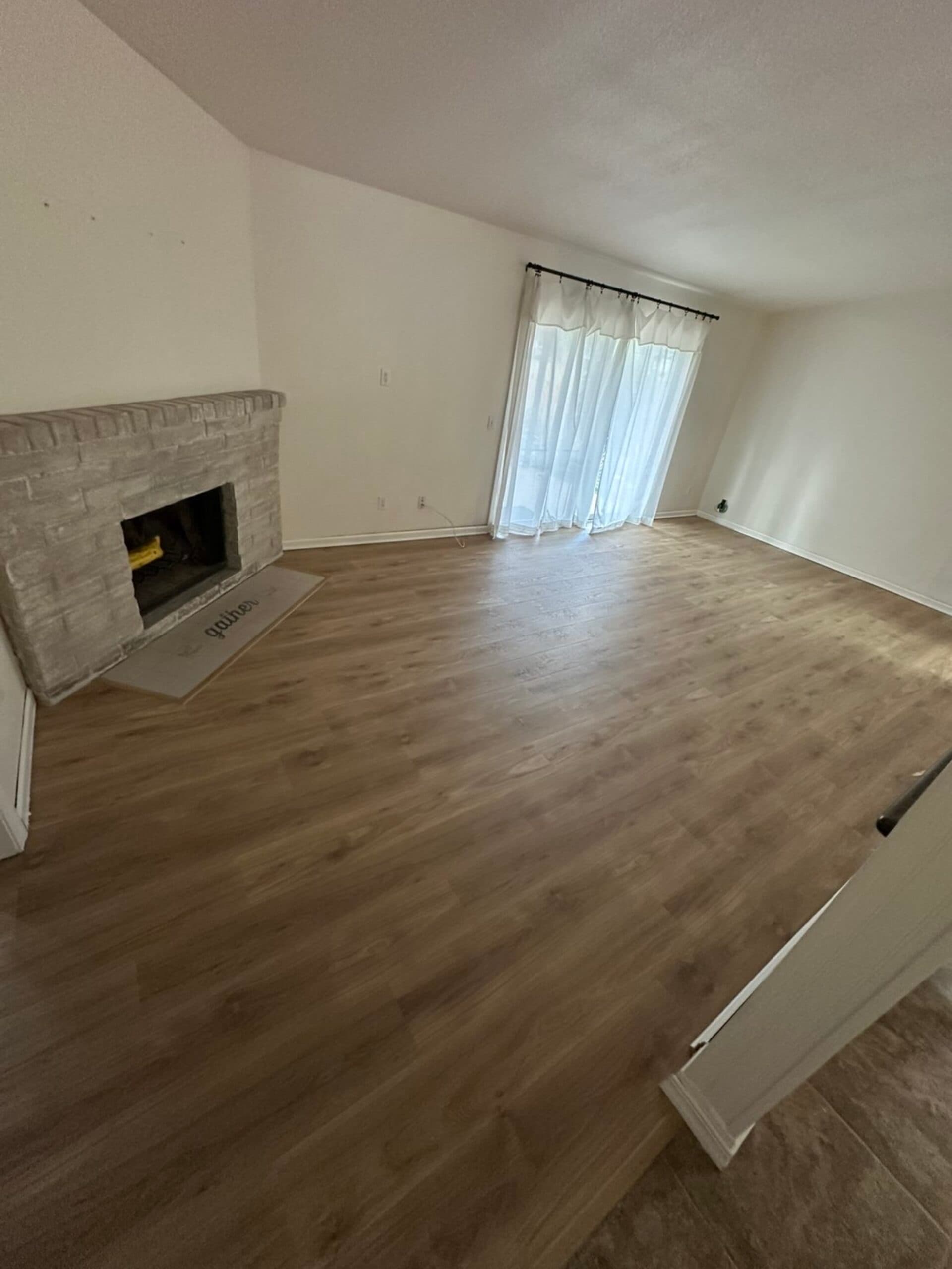 LVP flooring installation living room brick fireplace Vancouver WA